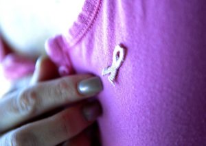person wearing small ribbon on t shirt close up