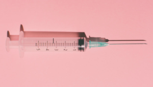 botox needle against pink background