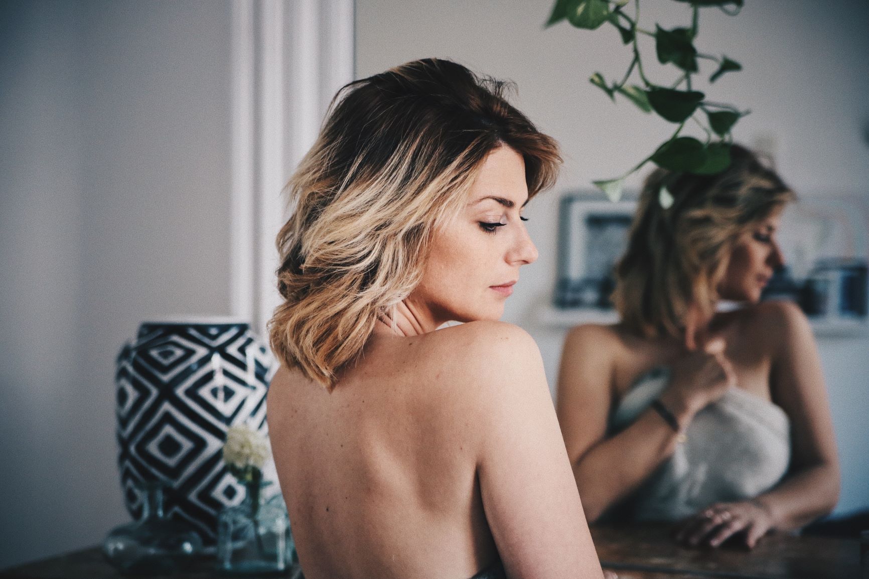 blonde woman in mirror with face turned away