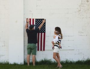 family holding American flag