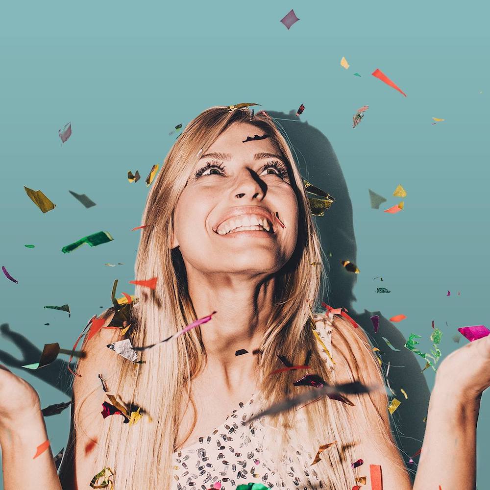 girl smiling at confetti