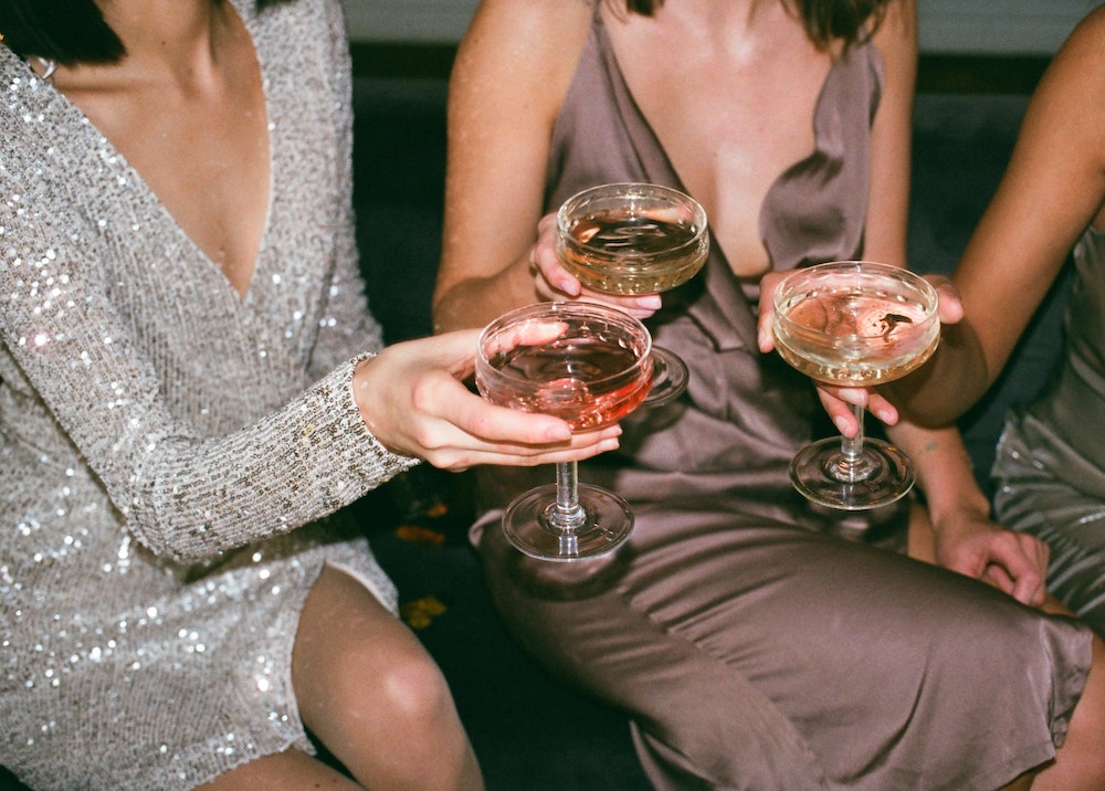 women in dresses holding drinks