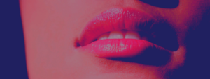 Lower half of woman's face with plump, pink/red lips