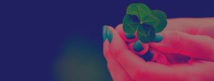 Woman holding four-leaf clover