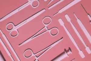 Pink graphic of scissors, needles, and other surgery tools