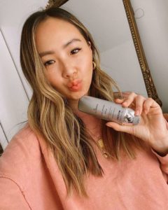 Female influencer holding mineral powder sunscreen