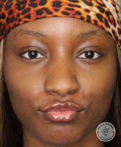 Young, black woman with puckered lips wearing a leopard headband