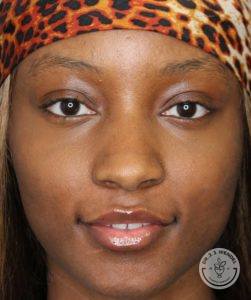 Close-up of a black woman's face with cheetah print headband