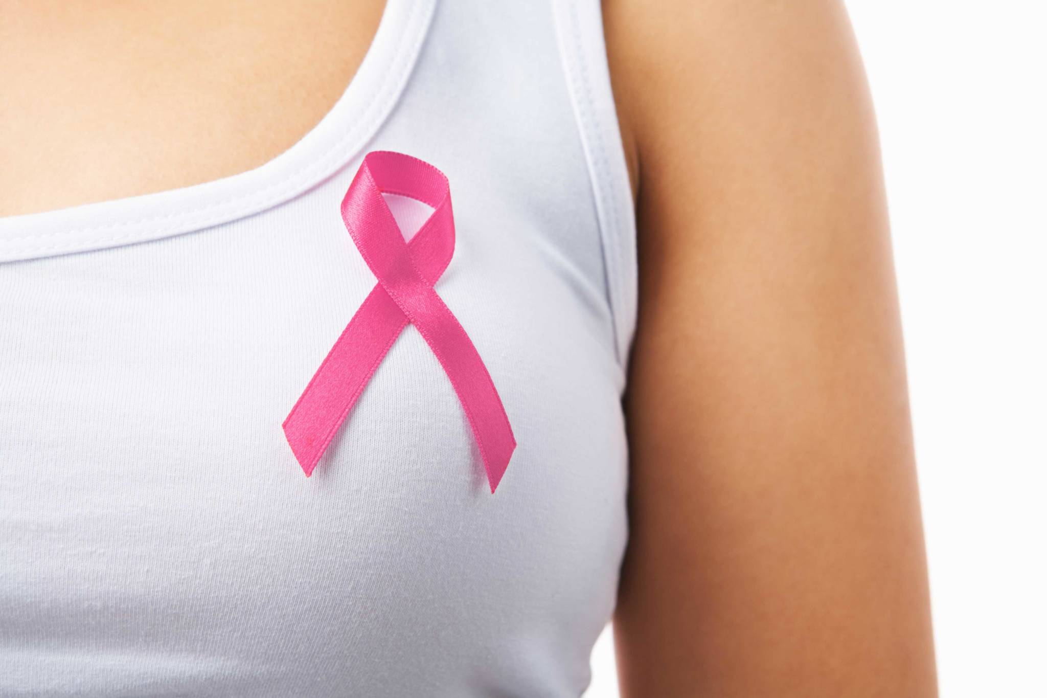 woman in white tank top wearing pink breast cancer awareness ribbon