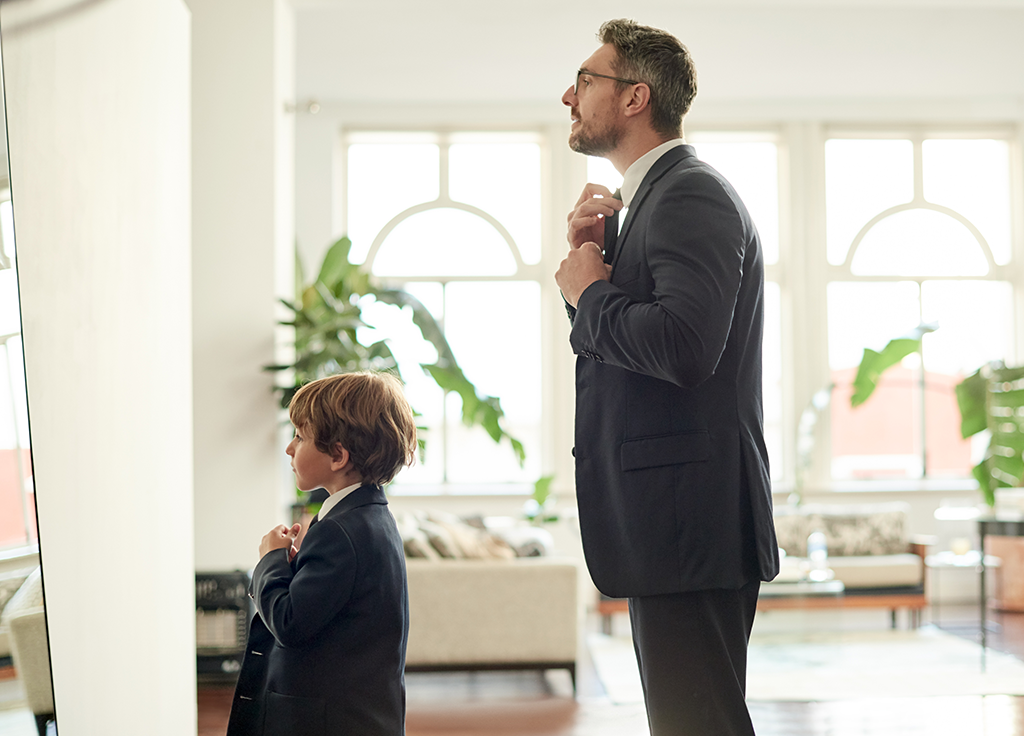 Dad and son looking in mirror