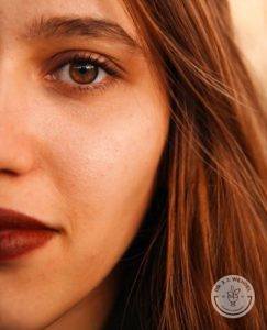 Close-up of brunette woman with brown eyes and red lipstick