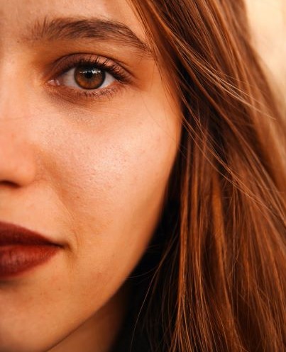 Close-up of brunette woman with brown eyes and red lipstick