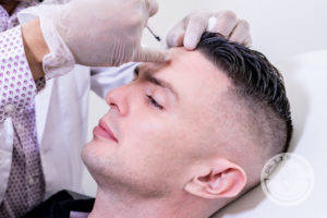 Man receiving filler on forehead