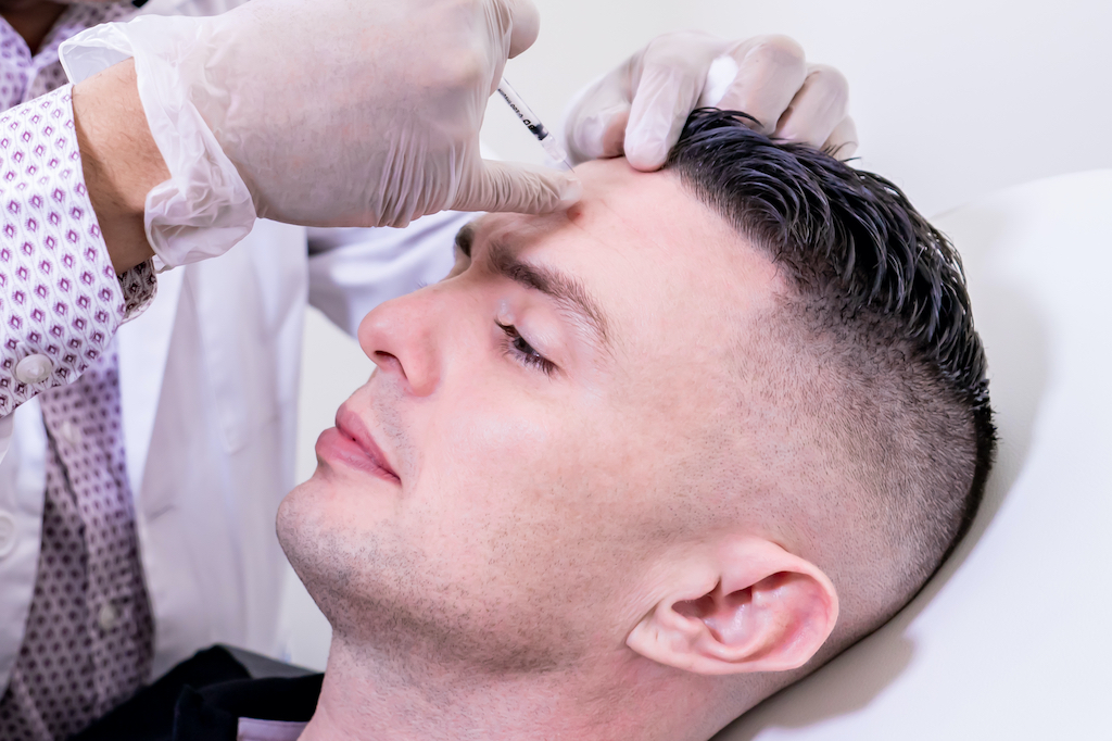 Man receiving filler on forehead