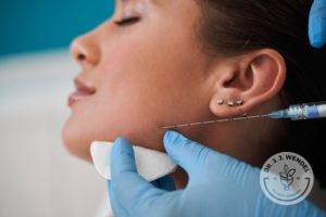 Woman receiving injection on face