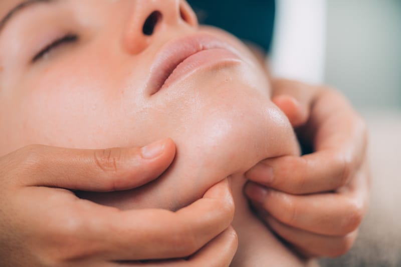 Woman Receiving a Jaw Massage