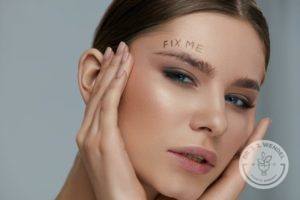 Woman holding hands near face with the words fix me above her eyebrow