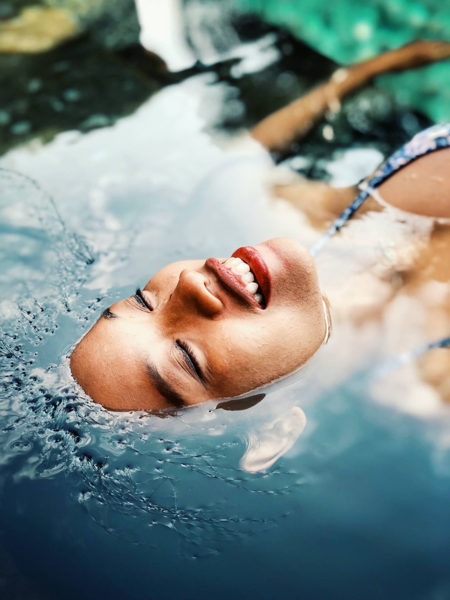 woman floating in a body of water with face above water