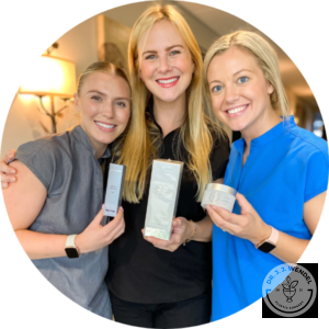 three female nurses smiling holding skin-care products