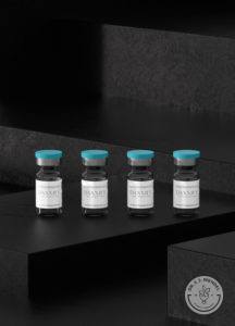 vials of Daxxify neuromodulator against black background