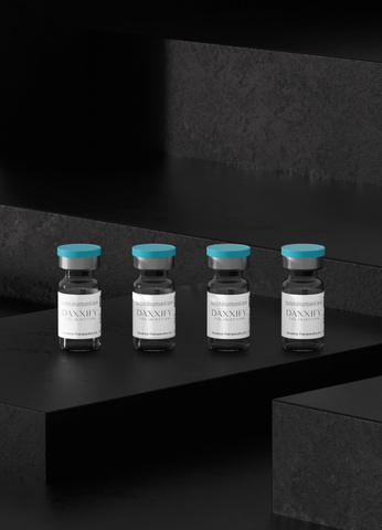 vials of Daxxify neuromodulator against black background