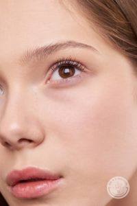 Close up of a brown eyed woman wearing no make-up