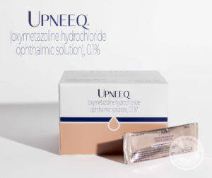 white box of Upneeq prescription eye drops with a sample placed next to box