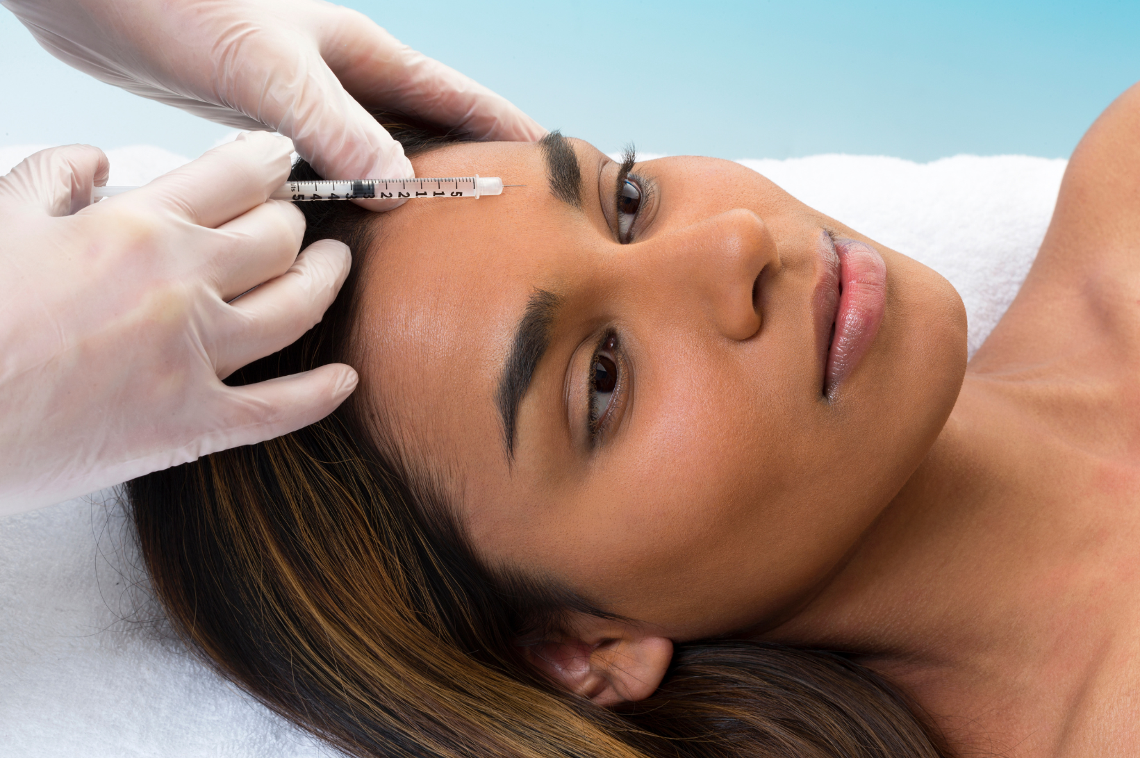 woman of color receives botox injection