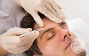 Man getting Botox injections to right side of forehead