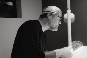 Dr. J.J Wendel plastic surgeon wearing gloves in procedure