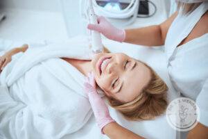 woman laying down receiving microneedling treatment