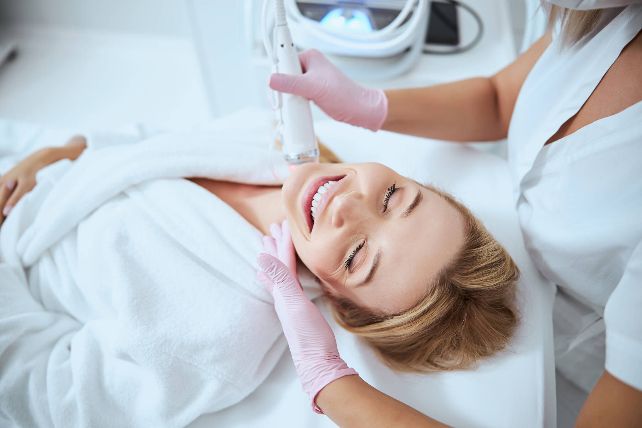 woman laying down receiving microneedling treatment