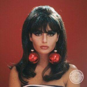 Brunette woman with retro 60s hairstyle wearing red Christmas Ornaments for earrings