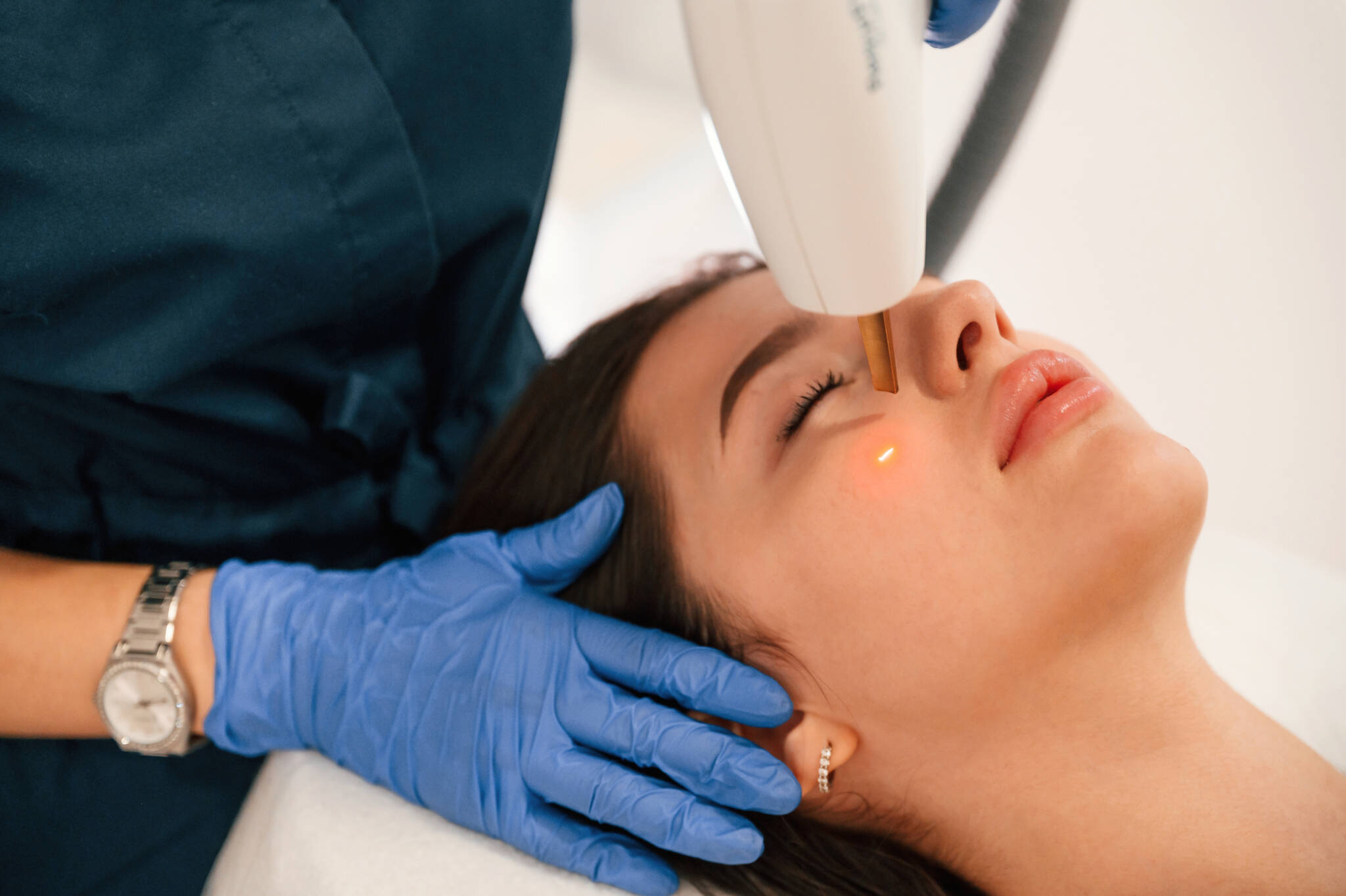 Young woman receiving a laser facial treatment