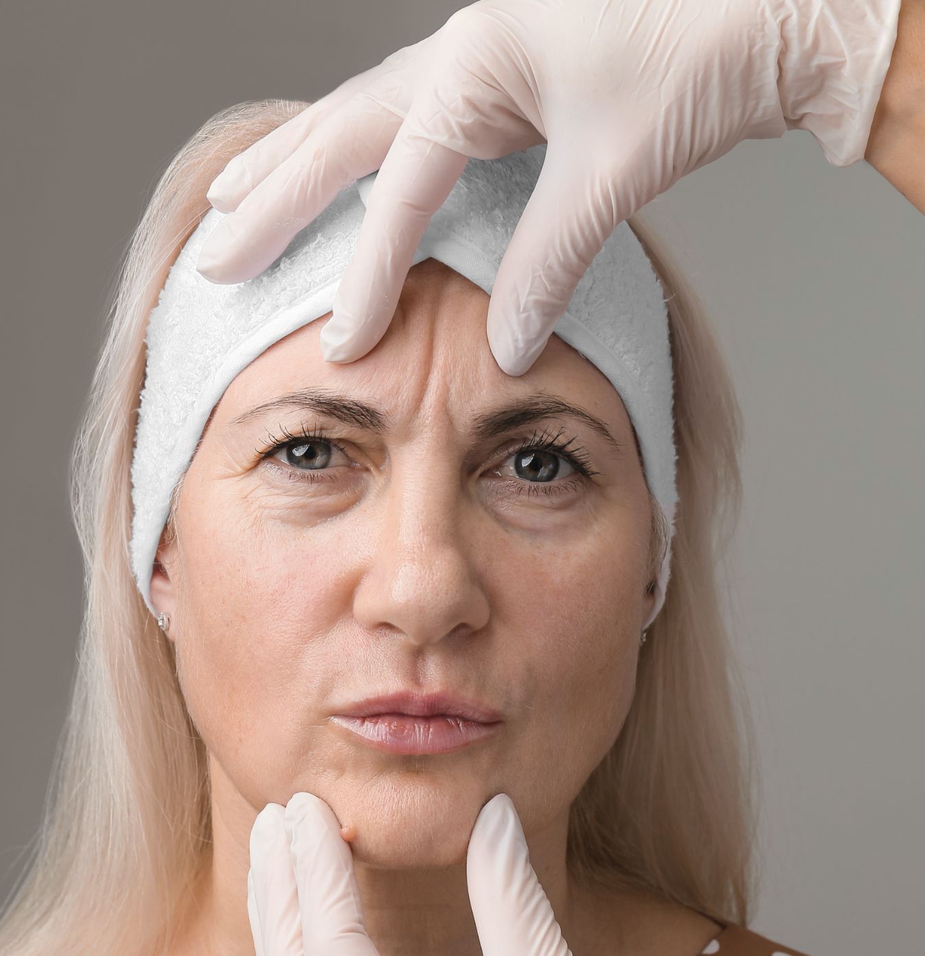 Face and body treatments. The concept of maintaining health, youth and beauty. Face masks, modern cosmetology, beautician tools, hands with gloves. Beauty techniques.