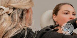 Woman receiving jawline injectable by a practitioner