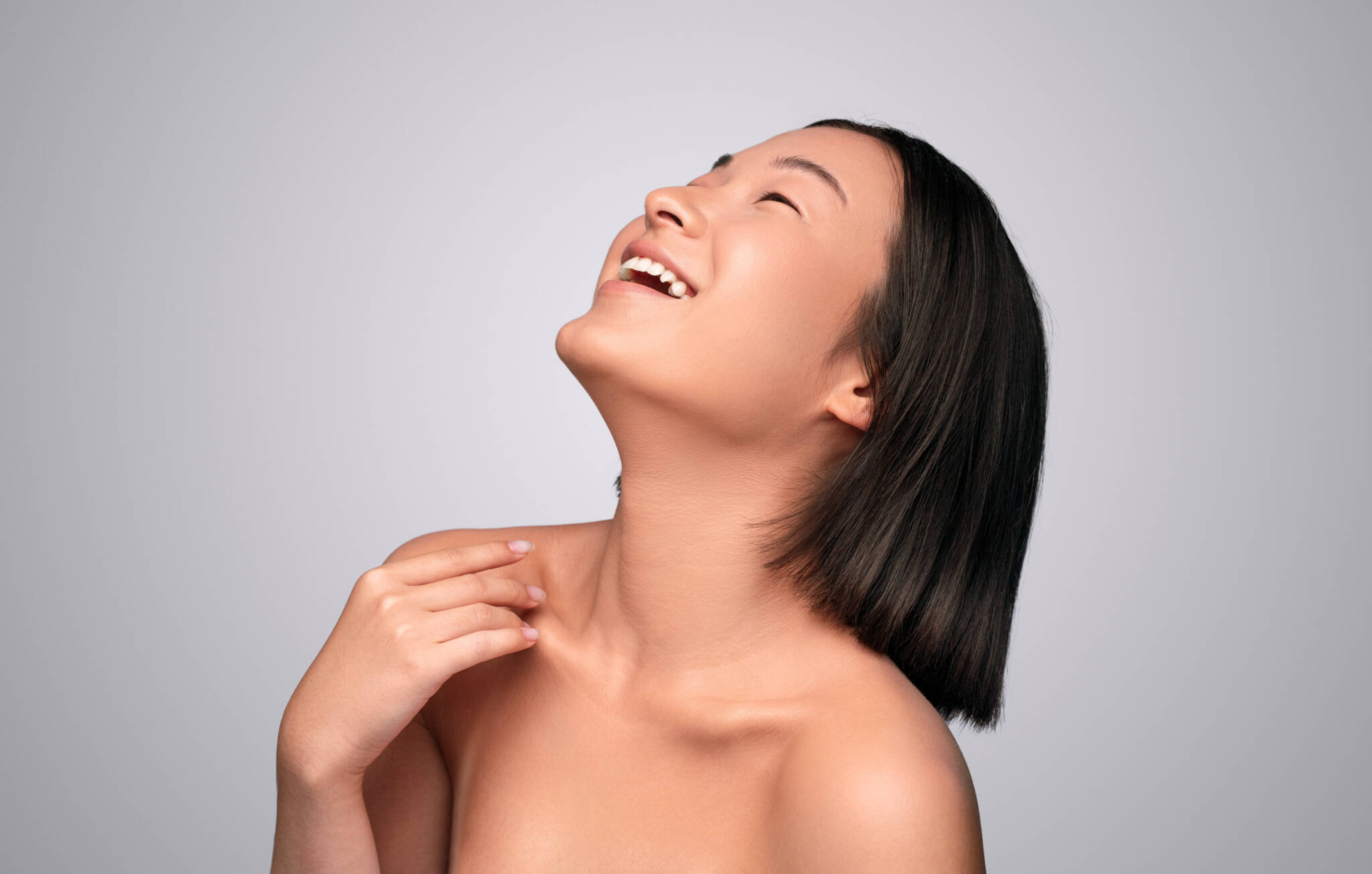 Woman enjoying her lack of chin fat after Kybella treatments.