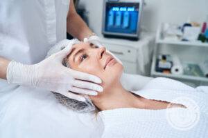 A woman lays and has her skin prepped for Juvederm Skinvive treatments for smoothness.