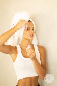 Young woman uses the Haus Glaze serum