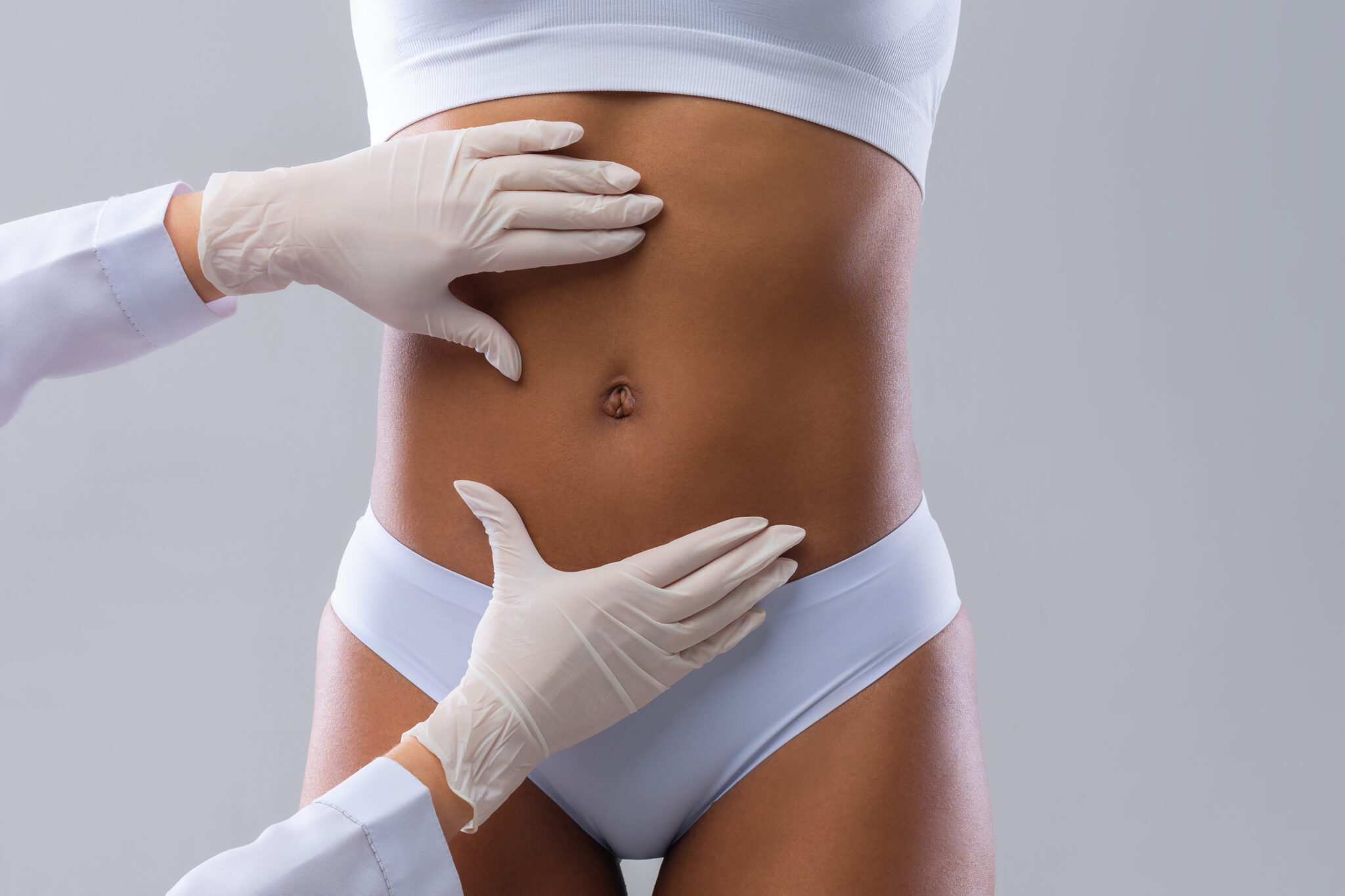 Woman has stomach area examined after a tummy tuck