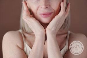 Woman examining her skin laxity