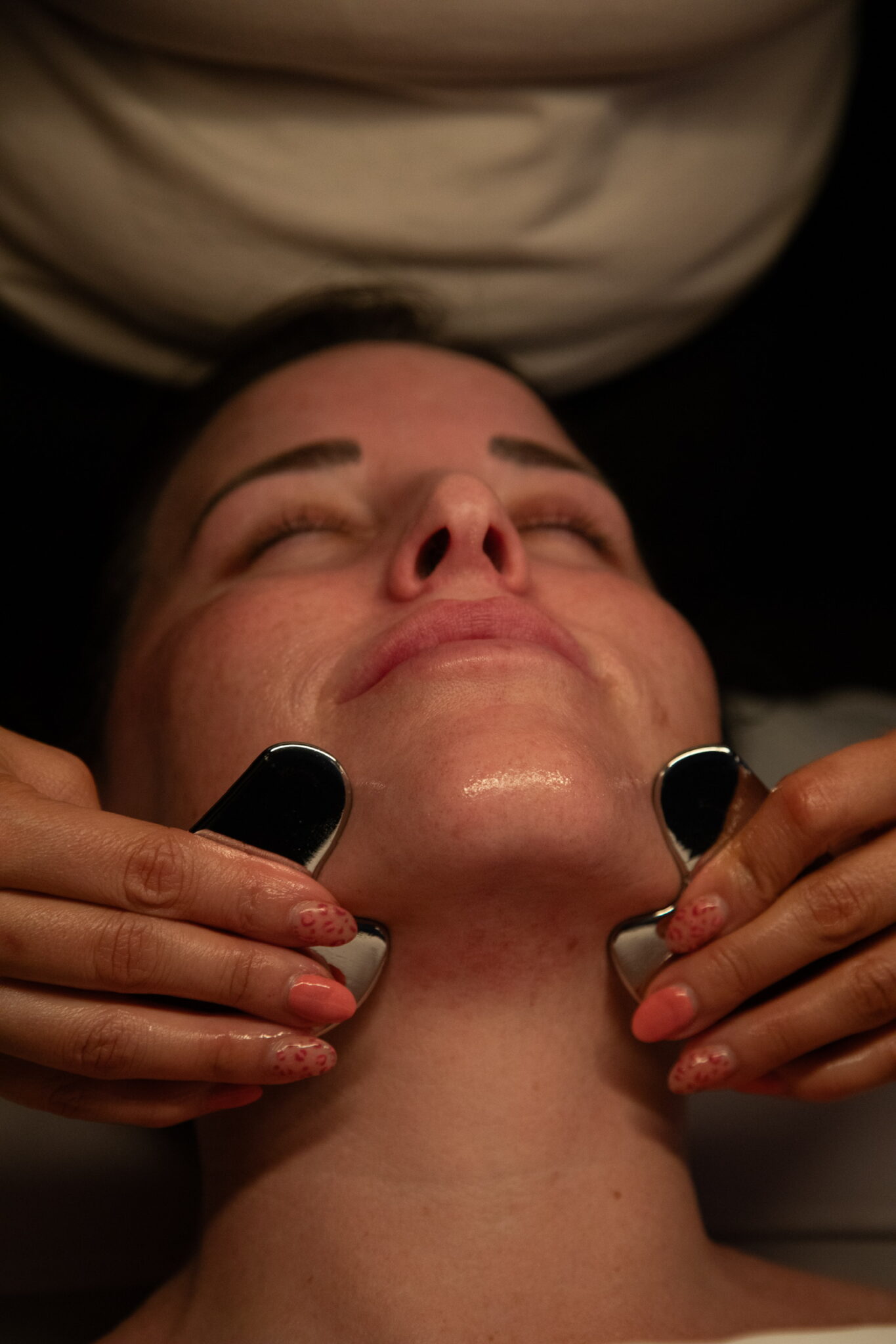 Female client receiving facial at SKINHAUS Beauty