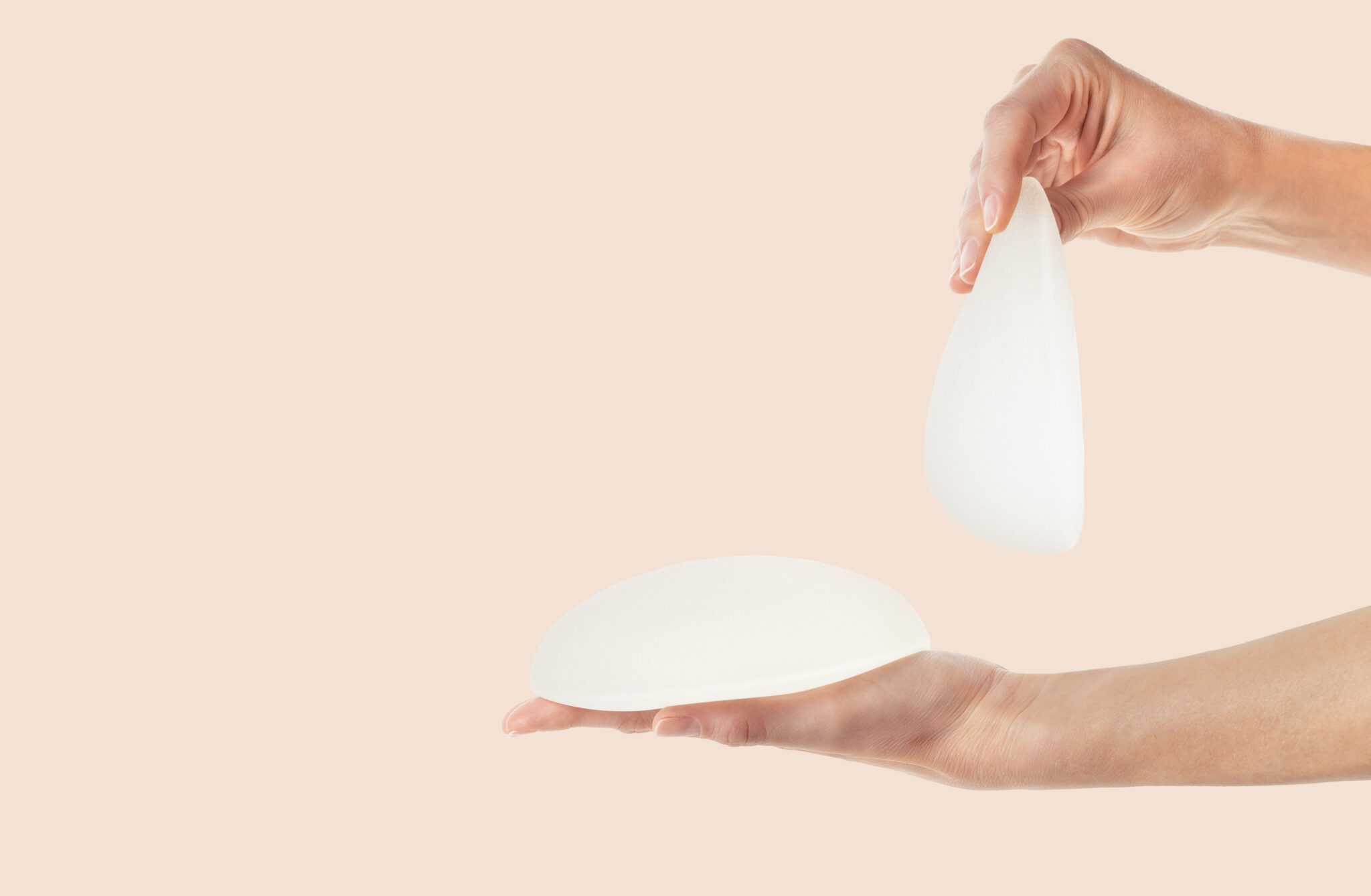 Breast implants being held up and laying flat