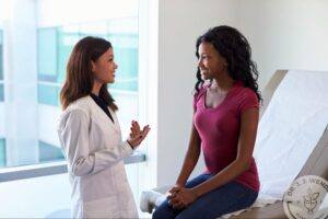 Plastic surgeon consulting with a patient to discuss thigh lift surgery and personalized body contouring options.