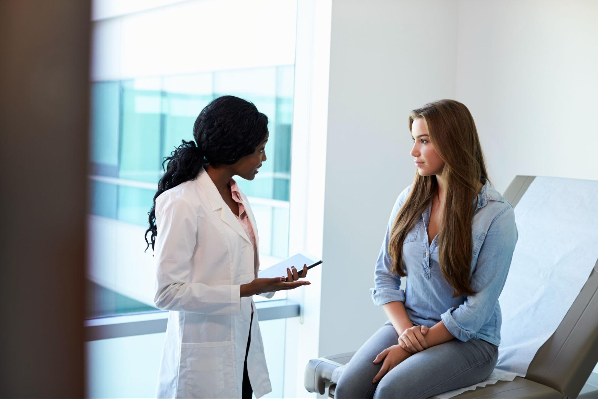 Plastic surgeon discussing breast reduction with a patient during a consultation