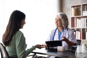 Plastic surgeon discussing breast fat transfer with a patient during a consultation